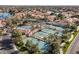 Aerial view of community tennis courts surrounded by lush landscaping and waterfront homes at 1101 N Peppertree Dr, Gilbert, AZ 85234