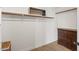 Walk-in closet with wood floors, a dresser, and ample shelving and hanging storage at 1101 N Peppertree Dr, Gilbert, AZ 85234