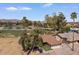 Aerial view displaying the home's desert landscaping, mature trees, and proximity to a golf course and lake at 11444 S 51St St, Phoenix, AZ 85044