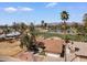 Aerial view of property showcasing desert landscaping, mature trees, proximity to a golf course, and nearby lake at 11444 S 51St St, Phoenix, AZ 85044