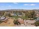 Wide aerial view of properties surrounding a golf course and lake in a desert landscape with mountain backdrop at 11444 S 51St St, Phoenix, AZ 85044