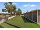 Expansive backyard showcasing artificial turf, stone features, and a charming swing set at 11444 S 51St St, Phoenix, AZ 85044
