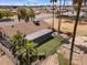 Landscaped backyard with enclosed porch, artificial turf and palm trees, perfect for relaxation and entertainment at 11444 S 51St St, Phoenix, AZ 85044