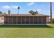 Spacious backyard featuring artificial turf, stone landscaping, and a screened-in patio at 11444 S 51St St, Phoenix, AZ 85044