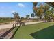Large backyard with artificial turf, stone landscaping, and a cozy patio swing facing the fairway at 11444 S 51St St, Phoenix, AZ 85044