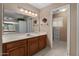 Bathroom featuring a double sink, wood cabinets, and tiled floors at 11444 S 51St St, Phoenix, AZ 85044