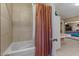 Bathroom showcasing tiled walls, a shower with curtain and glass door, and vanity at 11444 S 51St St, Phoenix, AZ 85044