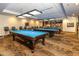 A billiards room featuring multiple tables, comfortable seating, and a stylish carpet perfect for recreational enjoyment at 11444 S 51St St, Phoenix, AZ 85044