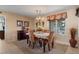 Well-lit dining room with traditional chandelier and view of the neighborhood at 11444 S 51St St, Phoenix, AZ 85044