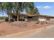 Quaint single-story home with mature tree coverage, desert landscaping, and an attached two-car garage at 11444 S 51St St, Phoenix, AZ 85044