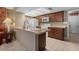 Open kitchen area with white appliances, wood cabinets, and a large sink at 11444 S 51St St, Phoenix, AZ 85044