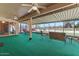 A covered patio with a green carpet, ceiling fans, and view of the open field at 11444 S 51St St, Phoenix, AZ 85044
