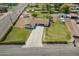 Aerial view showcasing the house with an extra building on a large lot, well-maintained with lawn and landscaping at 15202 N 71St Dr, Peoria, AZ 85381