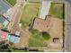 Aerial view of a single-Gathering home and its large well-maintained yard, featuring outbuildings and nice landscaping at 15202 N 71St Dr, Peoria, AZ 85381