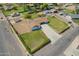 Aerial view of a single-Gathering home on a large lot, showcasing its generous green lawn and extended driveway at 15202 N 71St Dr, Peoria, AZ 85381