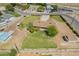 Aerial view of a single-Gathering home with a big yard, with additional outbuildings and landscaping at 15202 N 71St Dr, Peoria, AZ 85381