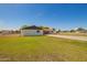 Large backyard featuring manicured lawns, secure fencing and a wide driveway at 15202 N 71St Dr, Peoria, AZ 85381