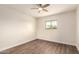 Bright bedroom features wood-look floors, a ceiling fan, and a window showcasing an outdoor view at 15202 N 71St Dr, Peoria, AZ 85381