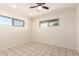 Bright bedroom with two windows and tile flooring at 15202 N 71St Dr, Peoria, AZ 85381