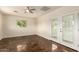 Bedroom with a ceiling fan, window and french doors leading outside at 15202 N 71St Dr, Peoria, AZ 85381