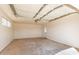 Spacious, unfinished garage with a functional door, offering potential for customization at 15202 N 71St Dr, Peoria, AZ 85381