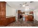 Stylish kitchen featuring cherry wood cabinets, granite countertops, and sleek, modern appliances at 15202 N 71St Dr, Peoria, AZ 85381