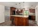 Kitchen showcasing cherry wood cabinetry, granite countertops, and a modern design at 15202 N 71St Dr, Peoria, AZ 85381