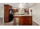 Kitchen island features wood cabinets, granite counters, and pendant lighting at 15202 N 71St Dr, Peoria, AZ 85381