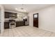 Open concept kitchen with stainless steel appliances and tile floor at 15202 N 71St Dr, Peoria, AZ 85381