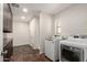 Laundry room with storage cabinets and new washer and dryer at 15202 N 71St Dr, Peoria, AZ 85381