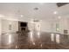 Spacious living room features tile floors, a cozy brick fireplace, and recessed lighting at 15202 N 71St Dr, Peoria, AZ 85381