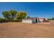 Large outbuilding with white exterior, ideal for storage or workshop space, plus gravel driveway and clear access at 15202 N 71St Dr, Peoria, AZ 85381