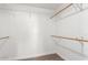 Bright walk-in closet with adjustable shelving and a rod for hanging clothes at 15202 N 71St Dr, Peoria, AZ 85381