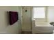 Bright bathroom featuring a glass-enclosed shower and a separate soaking tub at 15351 W Port Royale Ln, Surprise, AZ 85379