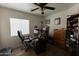 Bedroom with a ceiling fan and a large window offering natural light at 15351 W Port Royale Ln, Surprise, AZ 85379