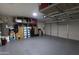 Well-lit garage with epoxy flooring, overhead storage racks and plenty of storage space at 15351 W Port Royale Ln, Surprise, AZ 85379