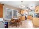 Cozy kitchen with tile flooring, oak cabinets, stainless appliances, and an adjacent dining area with natural light at 15351 W Port Royale Ln, Surprise, AZ 85379