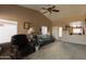 Inviting living room with vaulted ceilings, cozy seating, and abundant natural light at 15351 W Port Royale Ln, Surprise, AZ 85379