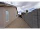Low maintenance side yard with gravel landscaping and block wall at 15351 W Port Royale Ln, Surprise, AZ 85379