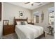 Cozy bedroom with a decorative headboard, a bedside table and neutral paint at 15434 W Big Sky Dr, Surprise, AZ 85374