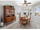 Cozy dining room features wood hutch, round dining table with four chairs, and three shuttered windows providing ample light at 15434 W Big Sky Dr, Surprise, AZ 85374