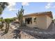 Home exterior with a covered patio, tile roof, and desert landscaping at 15434 W Big Sky Dr, Surprise, AZ 85374