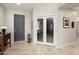 Bright foyer with tiled floors, leading to a study and other living spaces at 15434 W Big Sky Dr, Surprise, AZ 85374