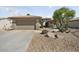 View of the home's facade, featuring a two-car garage and desert landscaping at 15434 W Big Sky Dr, Surprise, AZ 85374