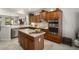 Spacious kitchen with stainless steel appliances, a center island, wood cabinets, and an open layout to the dining area at 15434 W Big Sky Dr, Surprise, AZ 85374