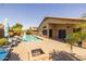 Private backyard oasis with pool, a rock waterfall, built-in fire pit, and a covered patio area at 16577 W Garfield St, Goodyear, AZ 85338