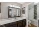 Bathroom featuring a single sink vanity and a tub/shower with tile surround at 16577 W Garfield St, Goodyear, AZ 85338