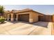Spacious driveway leading to a two-car garage, complemented by a neat, fenced side yard at 16577 W Garfield St, Goodyear, AZ 85338