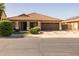 Charming single-story home featuring manicured lawn and a tile roof at 16577 W Garfield St, Goodyear, AZ 85338