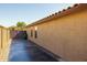 Side of house featuring a tile roof and a closed metal gate at 16577 W Garfield St, Goodyear, AZ 85338